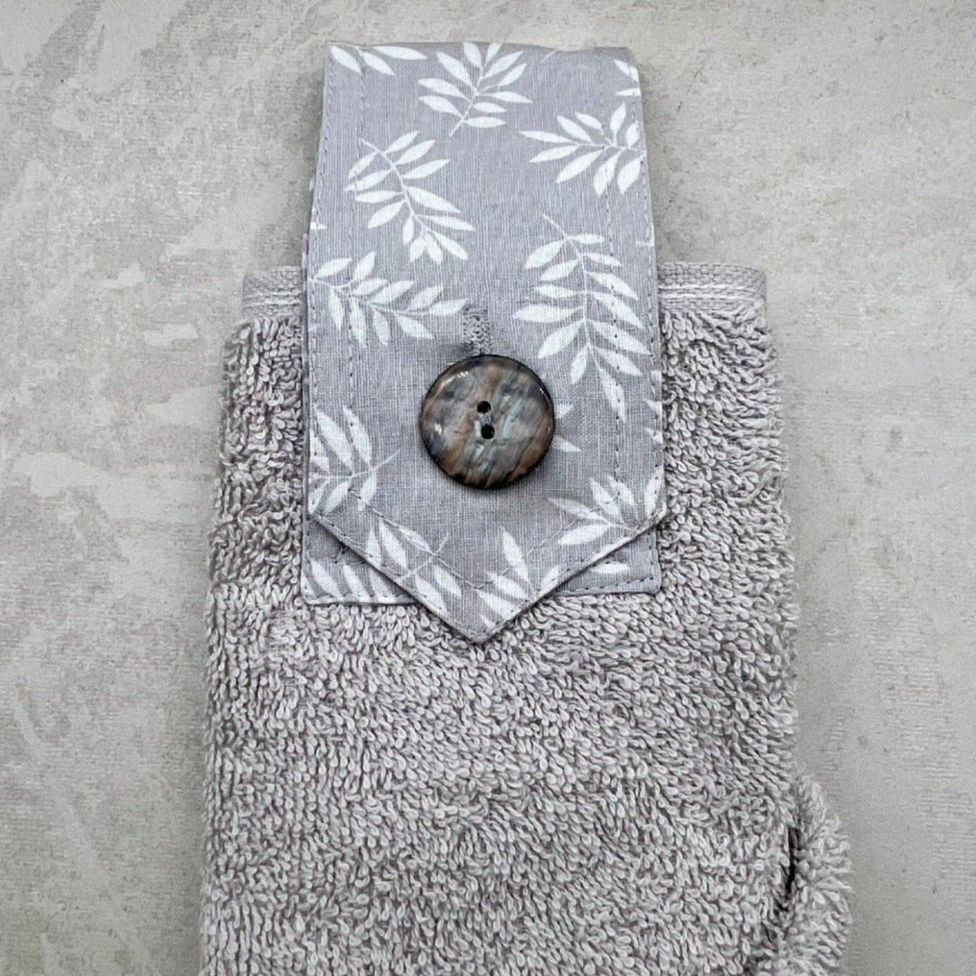 grey modern hanging hand towel with white leaves button loop