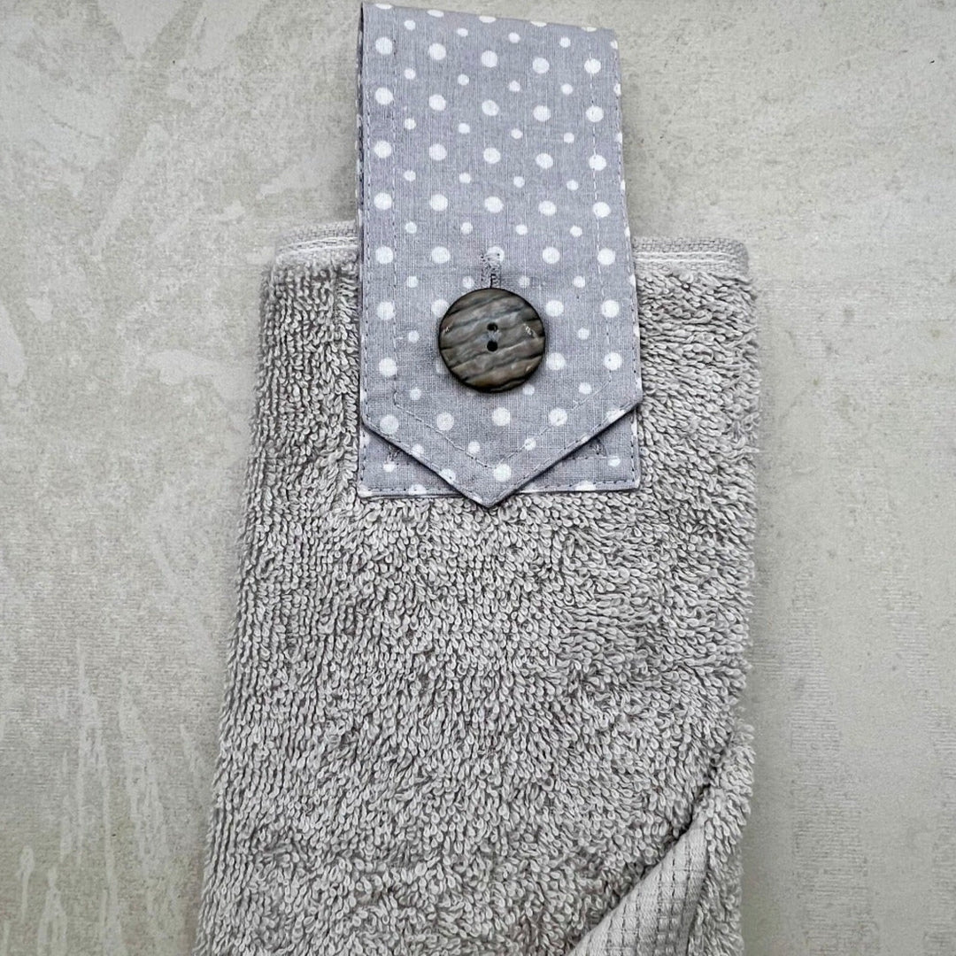 grey modern hanging hand towel with grey spotted button loop