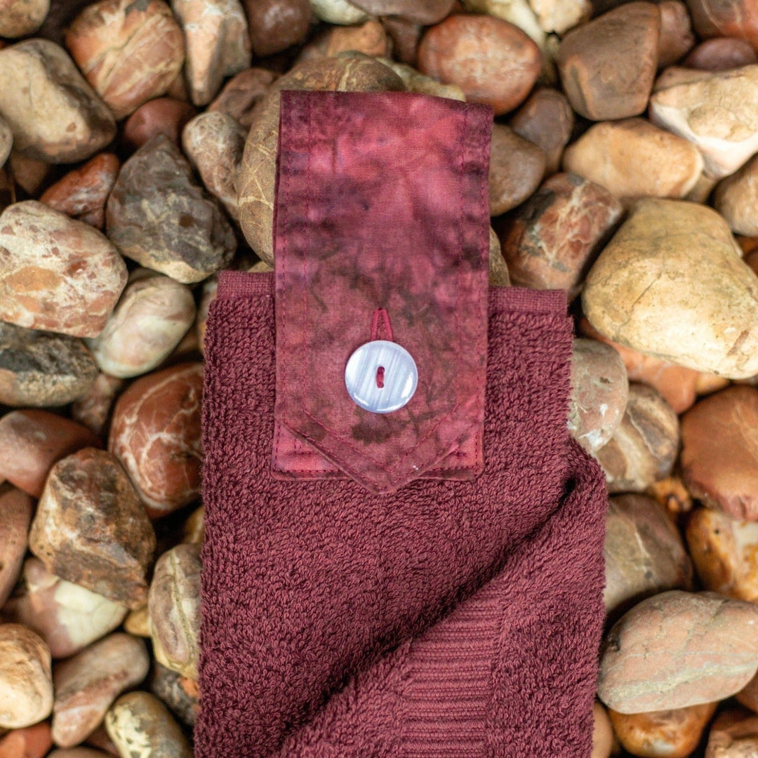 Burgundy coloured hanging hand towel. Made using the whole premium hand towel and quality cotton tab sewn to make a loop and secured with a beautiful modern button.